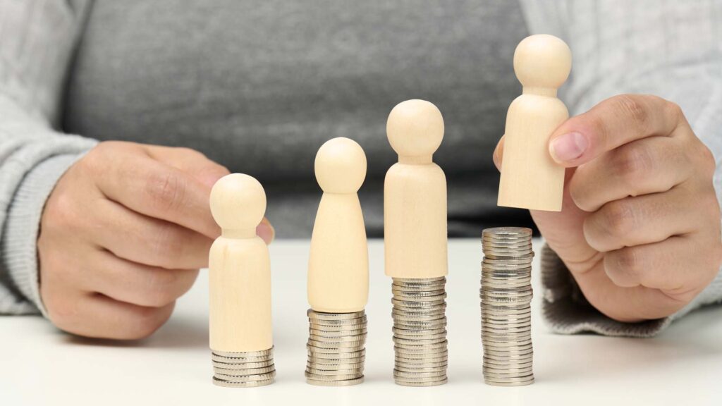 social_investing_wooden_figures_on_coins